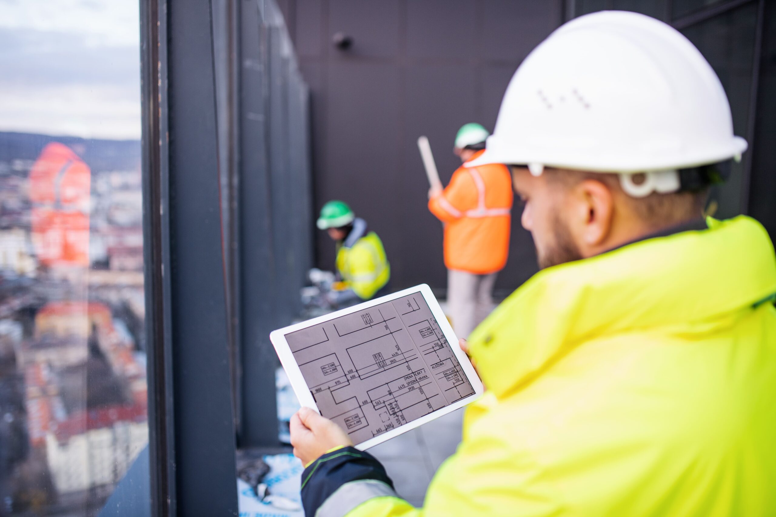 man engineer standing construction site holding tablet scaled - buildcontrol.sk